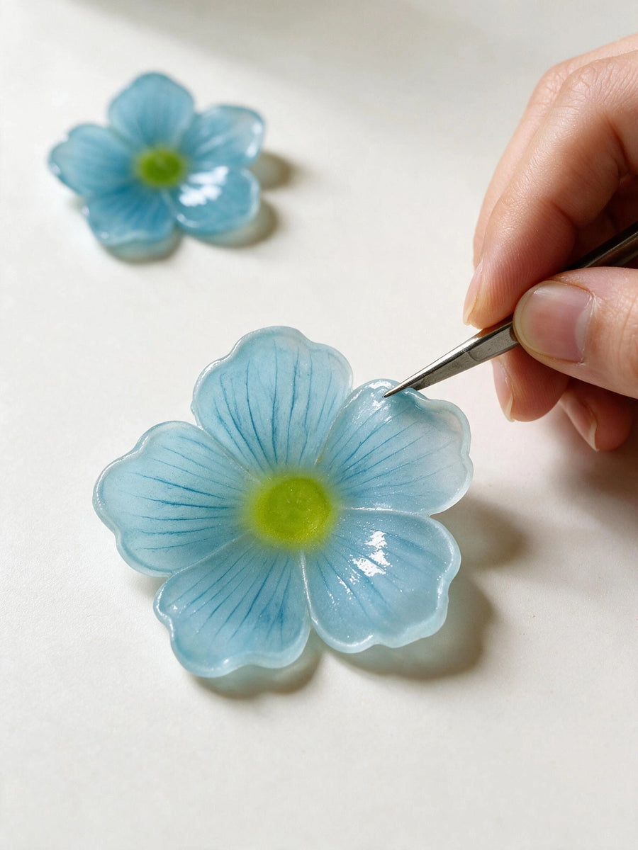 Handmade blue forget-me-not flower being finished for a personalized pet memorial shadow box