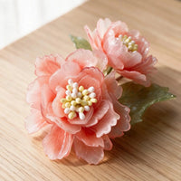 Close-up of handmade peonies inside a personalized pet celebration shadow box