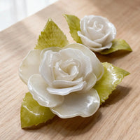 Close-up of handmade white roses inside a personalized pet memorial shadow box