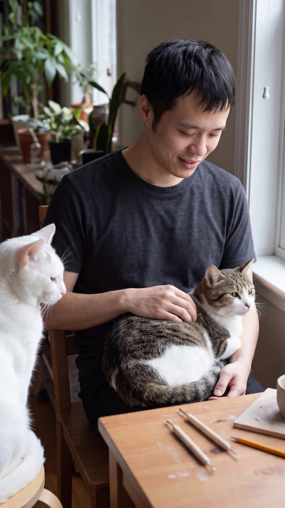 Andy, founder and maker of YP Pets, with his cats MiMi and DiDi.